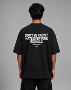 Back view of model wearing black oversized t-shirt with Don't Be Racist Hate Everyone Equally text print